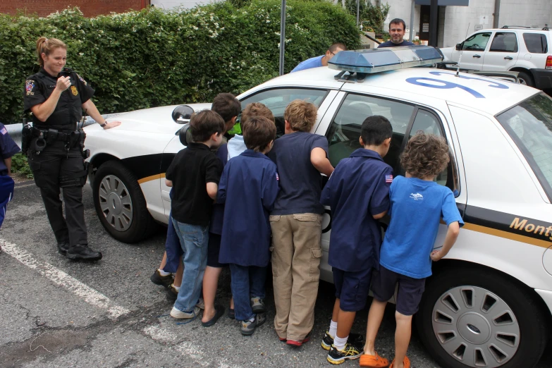 several boys standing around an ambulance at the scene
