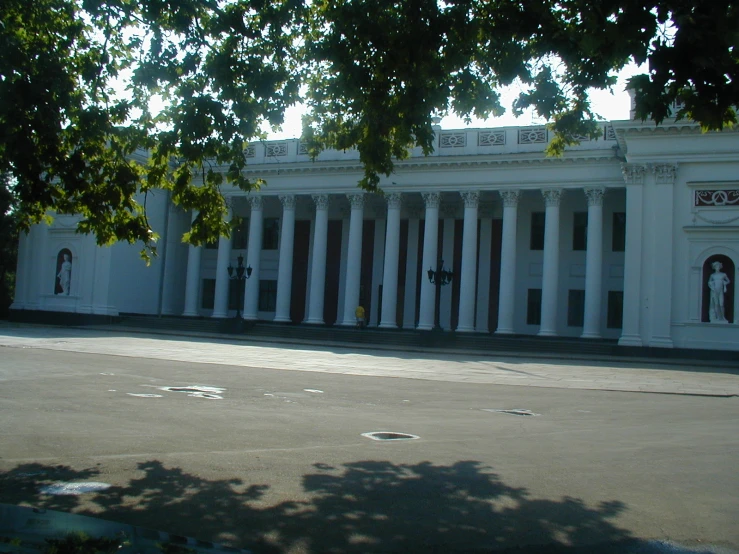 a white building with columns and arched windows