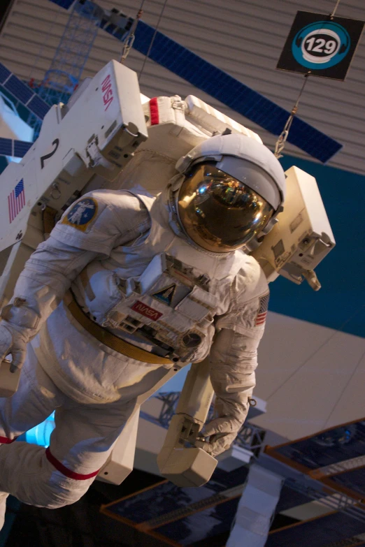 an astronaut walking past a white space station building