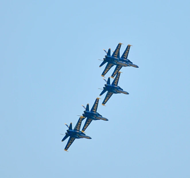 five blue fighter jets flying in formation in the sky