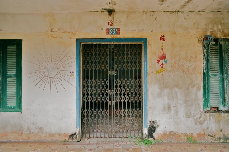 a gate opens into a room with blue shutters