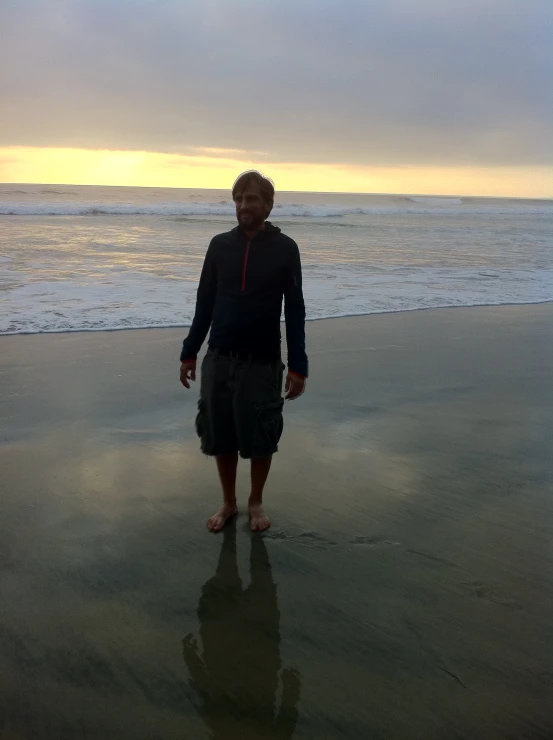 a person stands on a beach with the ocean in the background