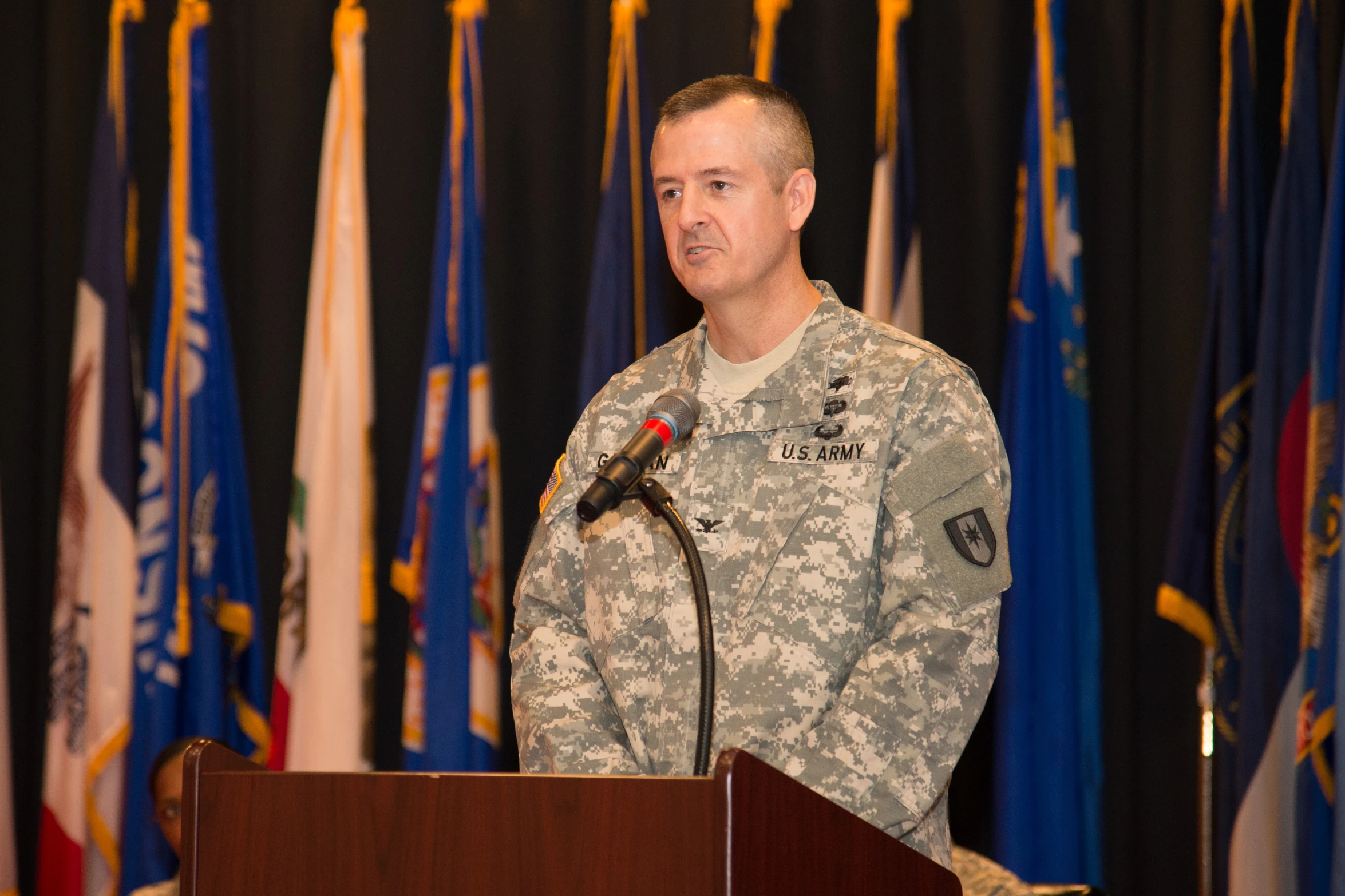 a man in military uniform standing at a podium