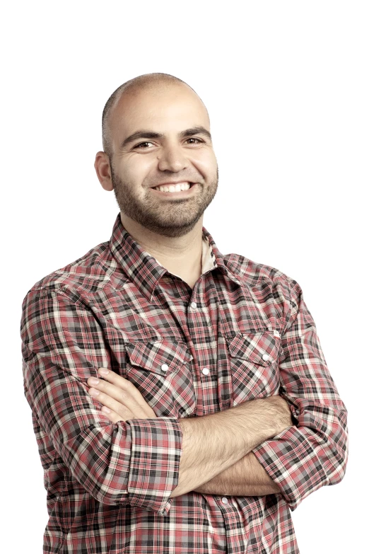 a smiling man in checkered shirt with his arms crossed