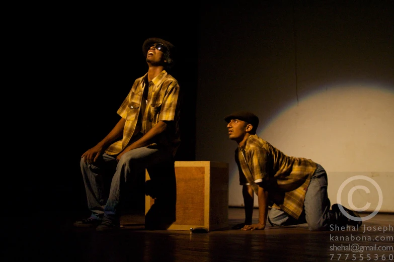 a group of men standing on top of a wooden block