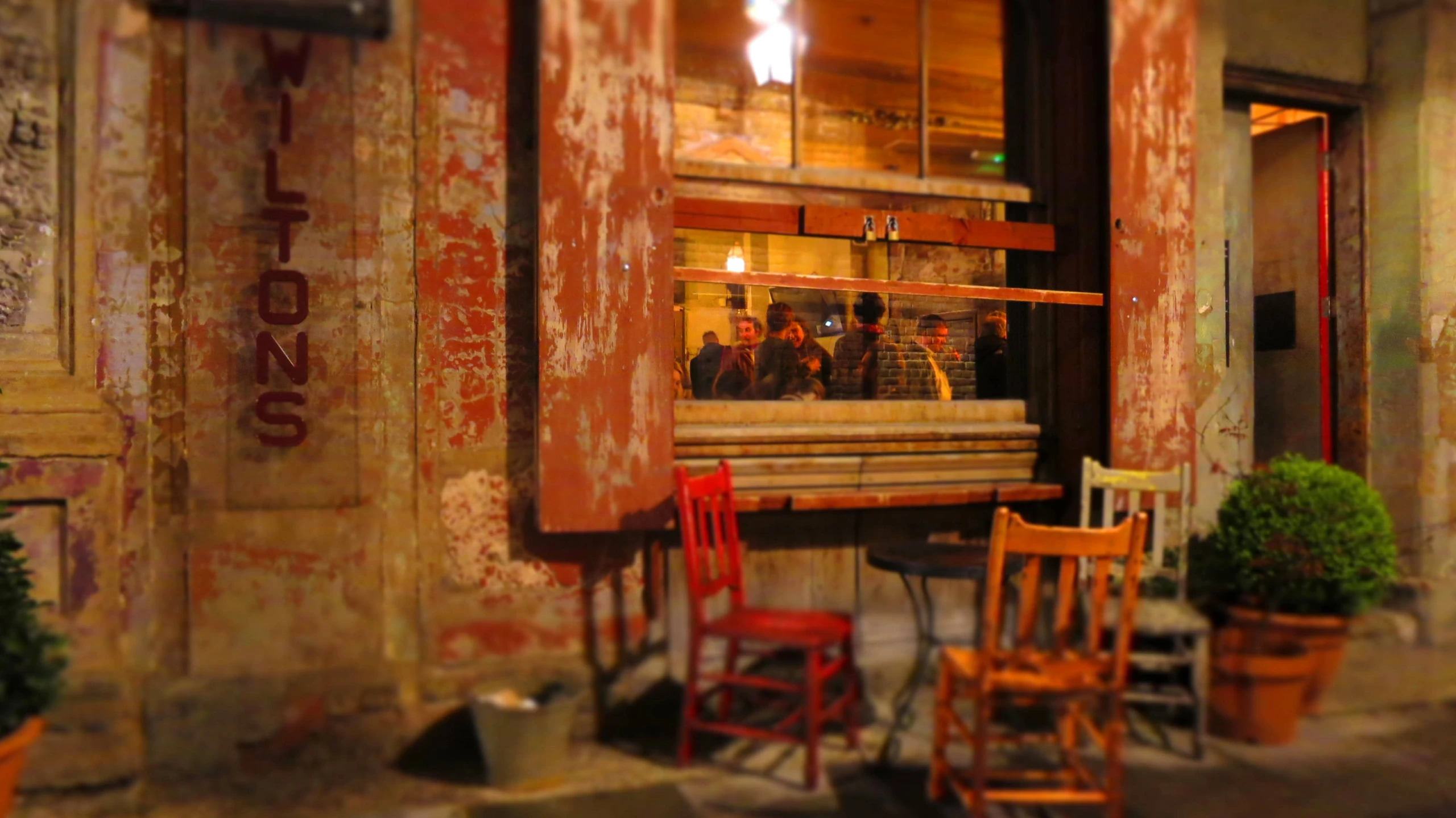 a cafe is lit by the light from an outdoor window