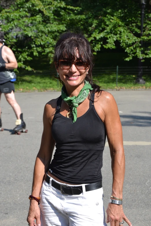 an attractive woman wearing a bandana and sunglasses is in an outdoor area