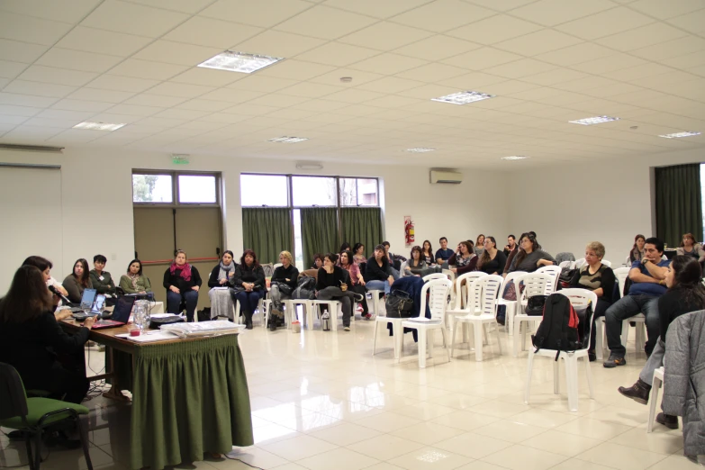 a crowd of people sitting down in a classroom