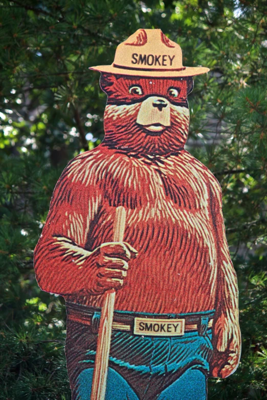 a very large sign with a man in a hat and bear in fireman uniform