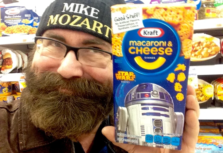 a man with a dog bun and a star wars cap in front of his face