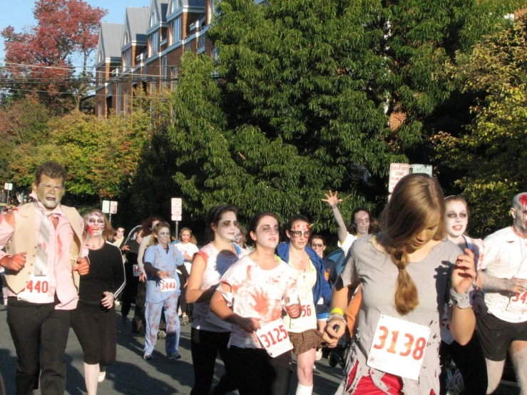 a crowd of people are running in a marathon