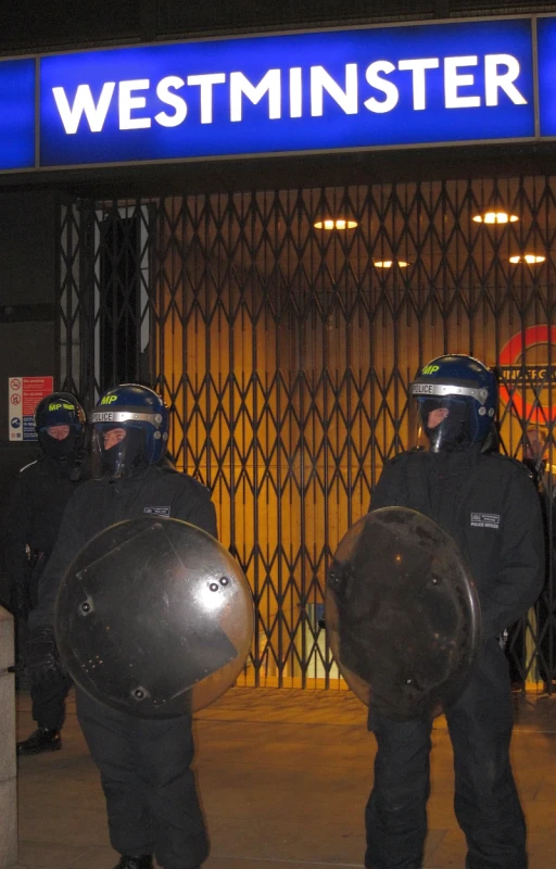 a couple of people in riot gear with helmets