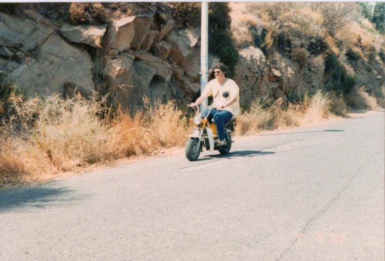 a man is riding a motorcycle down the road