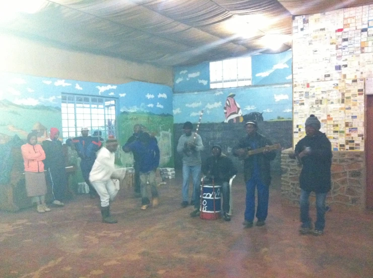 a group of people stand in a room with many blue walls