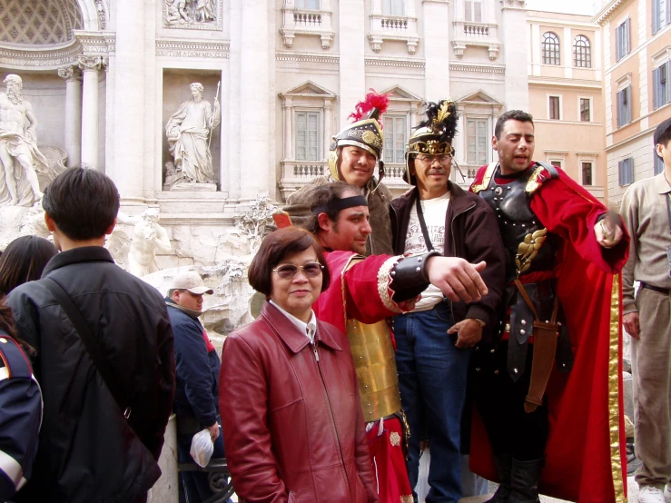 people in costumes taking pictures of a group of people