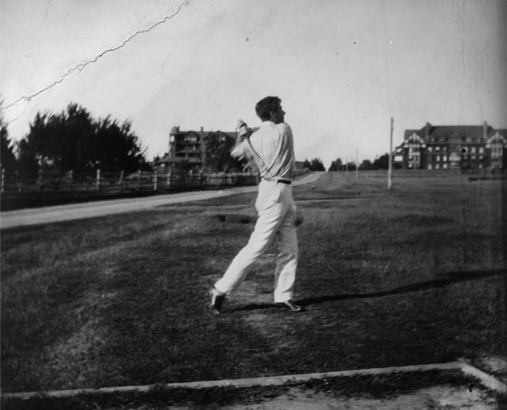 a black and white po of a baseball player holding a bat