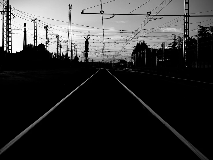 the silhouette of train tracks is shown in this black and white po