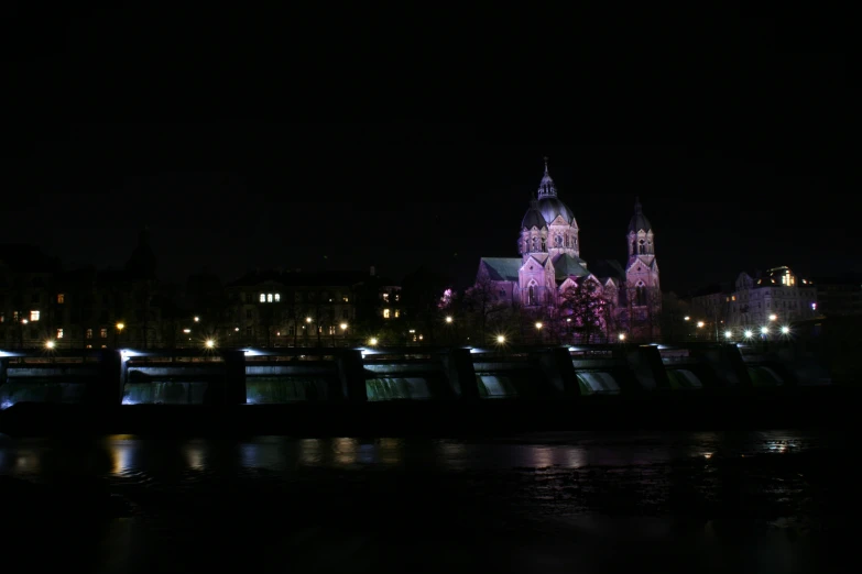 a castle and bridge in the night time