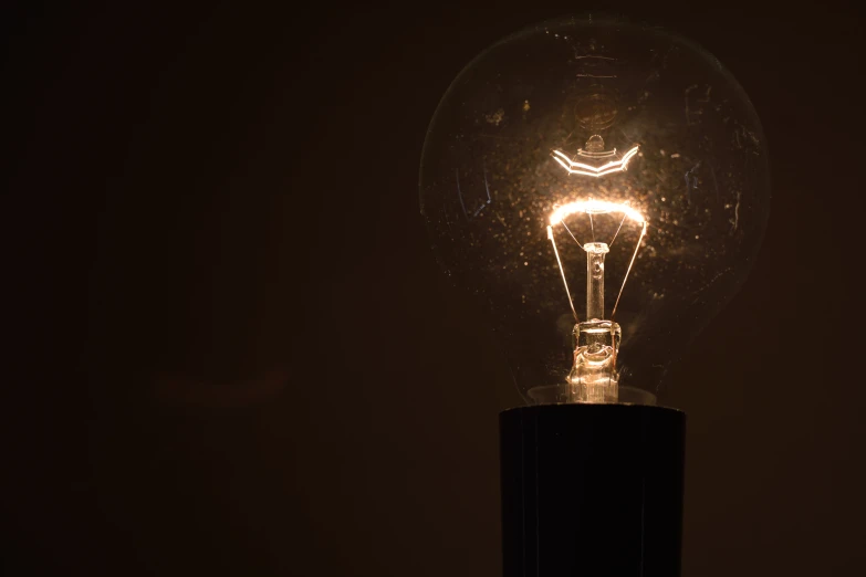 an illuminated bulb in the dark with a light shining on it