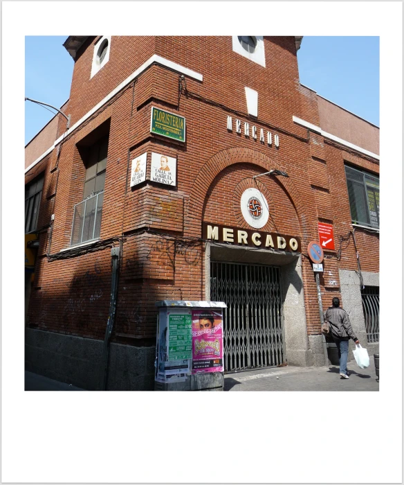 the corner of a brick building with a clock tower