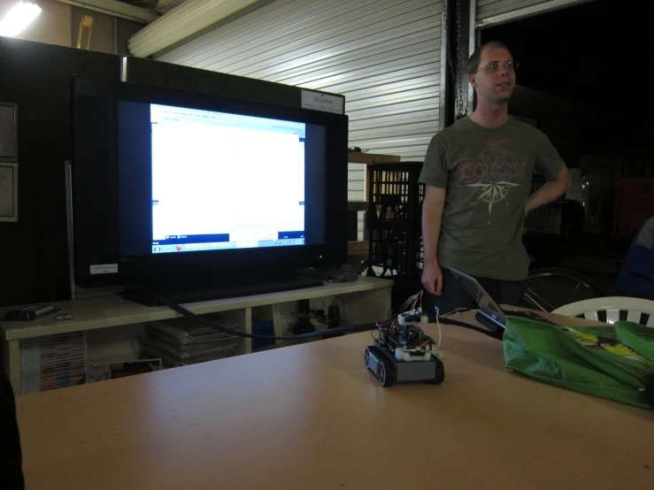 a man that is standing in front of a tv