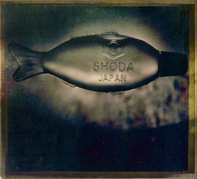 an advertit for shoda japan with fish shaped bottle
