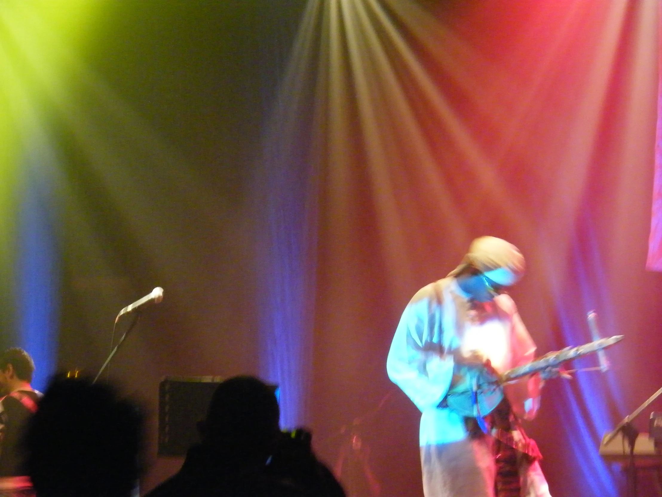 a man that is on stage with guitar