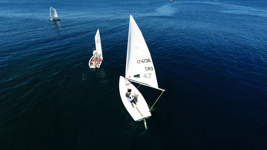 a couple of boats with oars are in the water