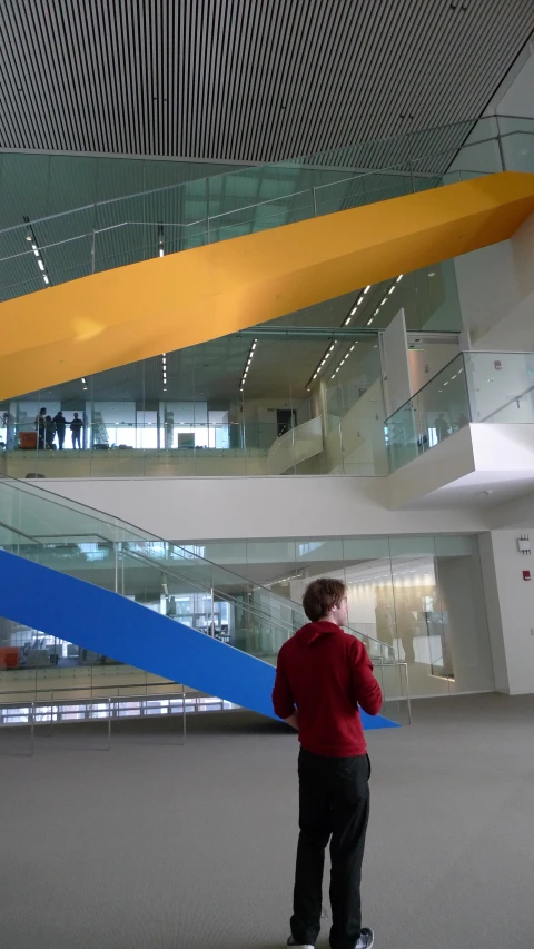 a man is looking at soing behind him in front of some stairs