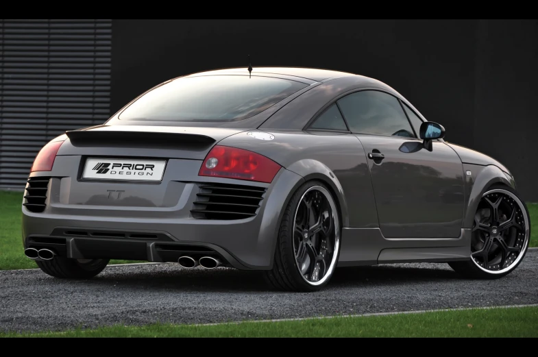 the rear end of a grey sports car