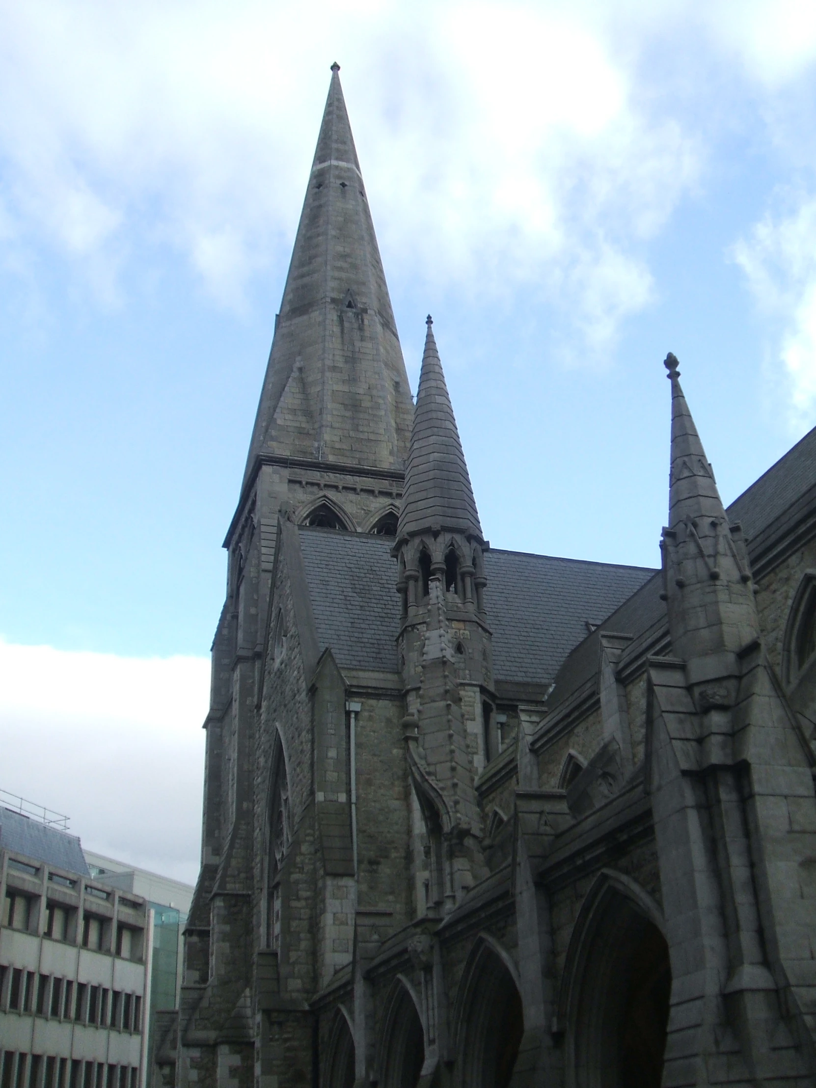 an old gothic church surrounded by an urban city