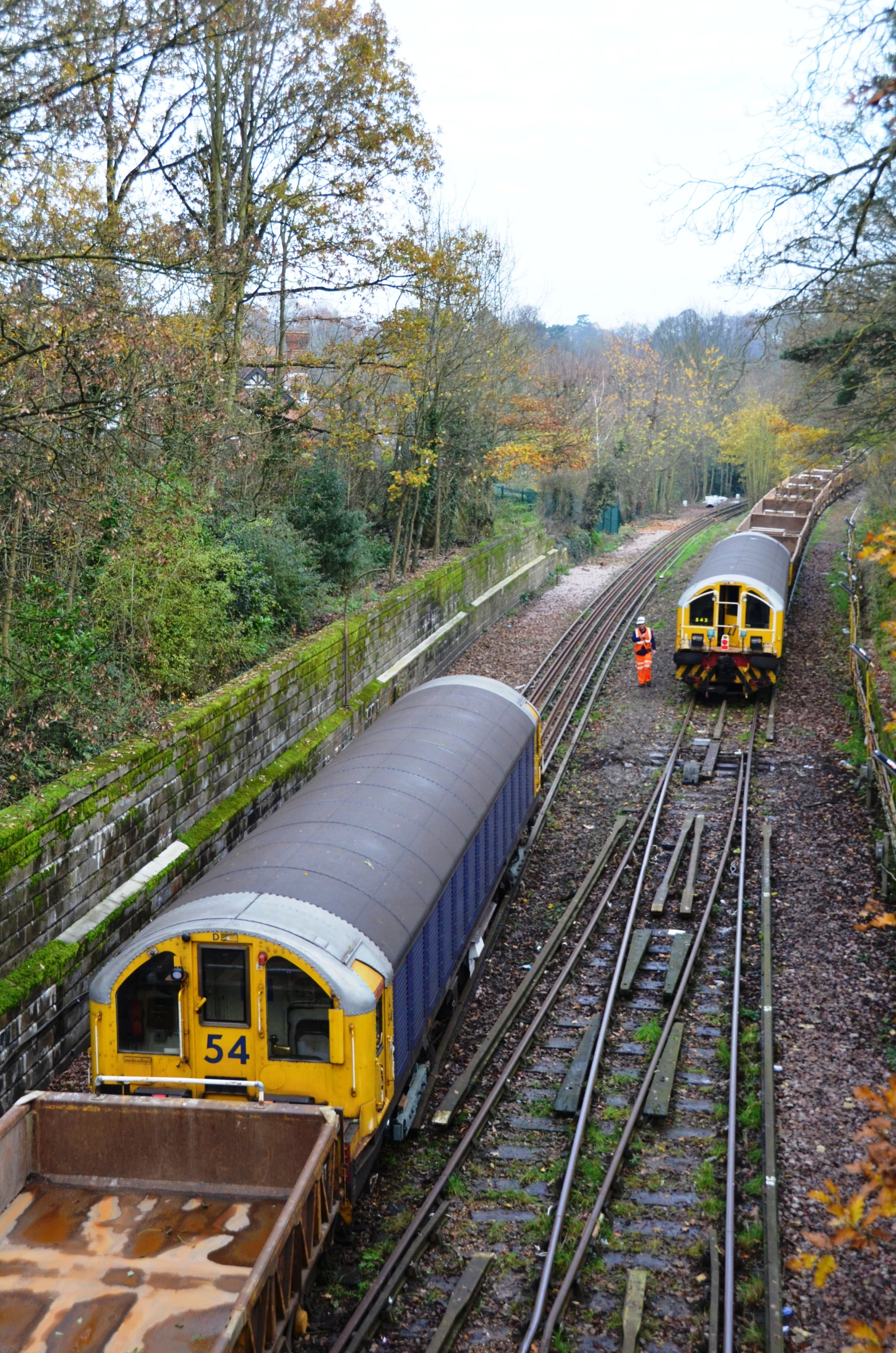 two yellow and black train engines sitting on top of train tracks