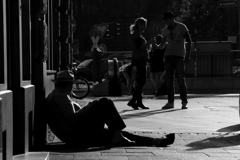 a man sitting on the ground in front of a crowd of people