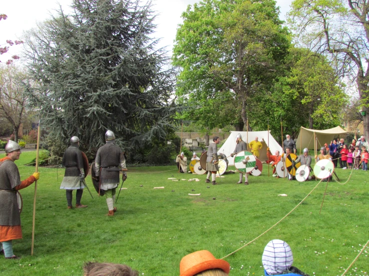 two medieval men with helmets and swords on the field