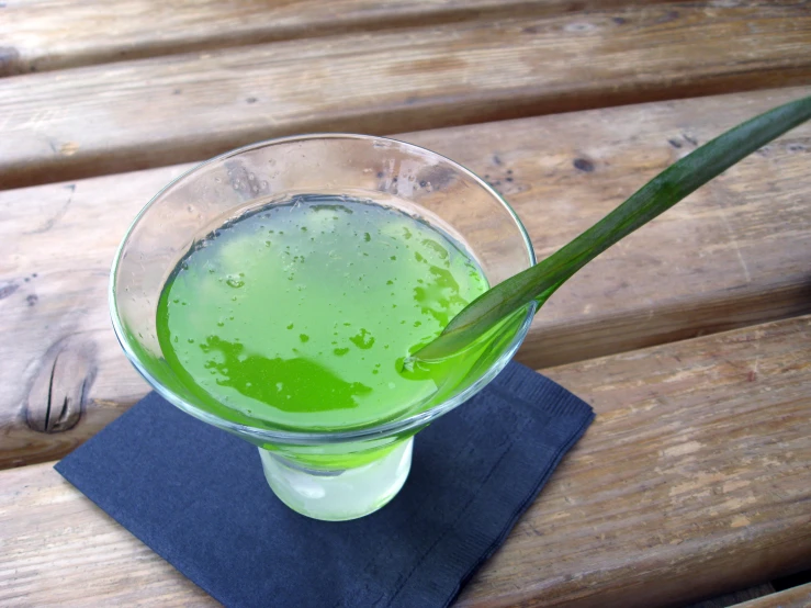 a drink with green liquid in a glass