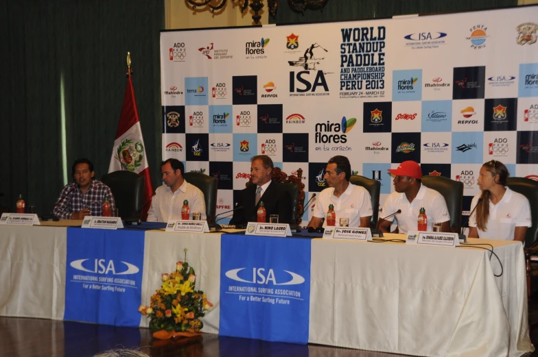 a group of people are sitting at a panel