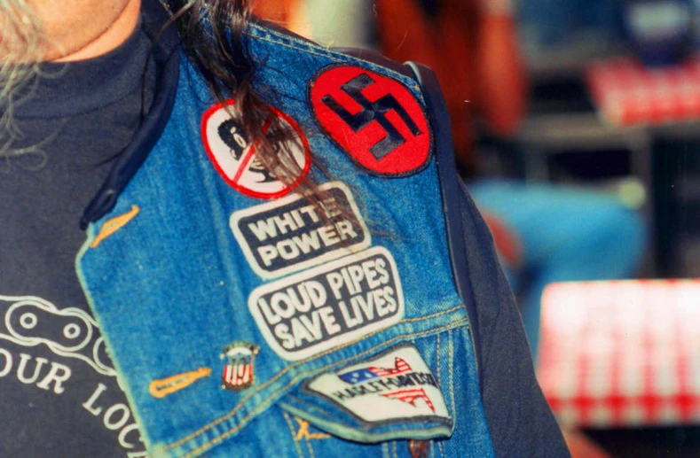 a close up of a person wearing patches on their jacket