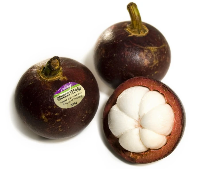 a close up of two fruit on a white surface