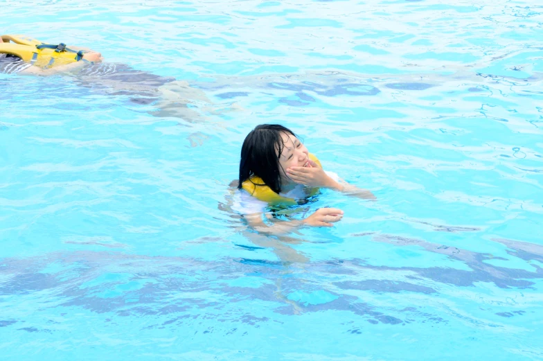 a woman standing in a pool next to a man