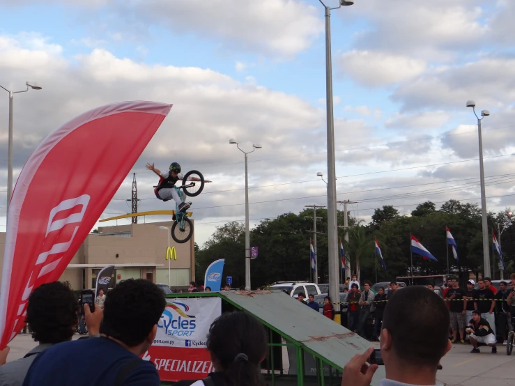 a man flying through the air while riding a bicycle