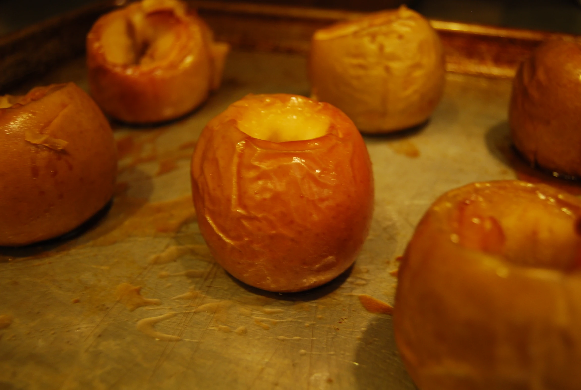 donuts baked on a pan covered in caramel sauce