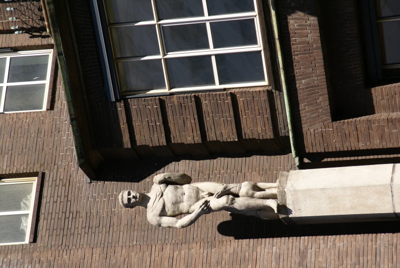 a statue on top of a building in front of a window