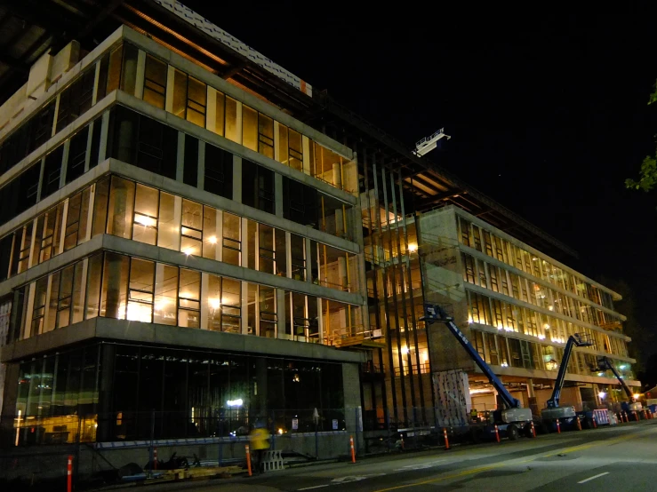 a building with windows on the outside is lit up at night