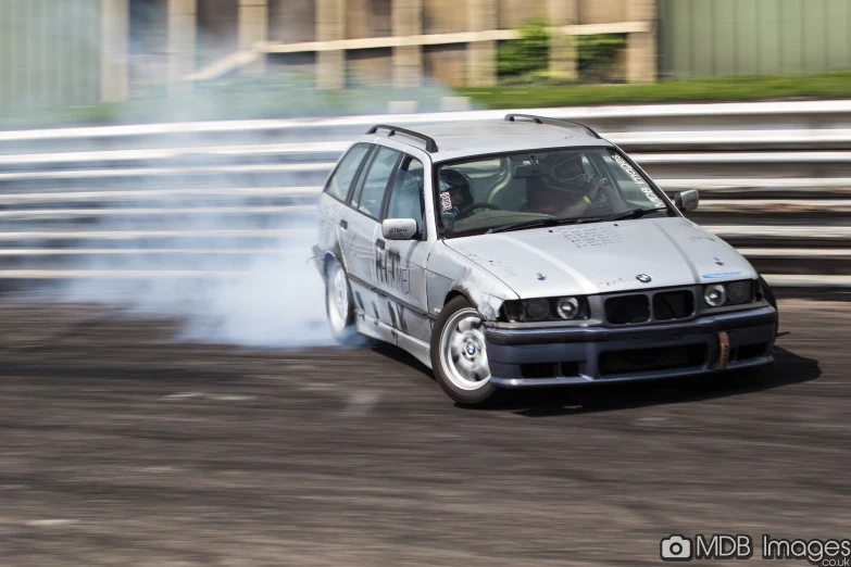 a white car with smoke coming out of it's windows