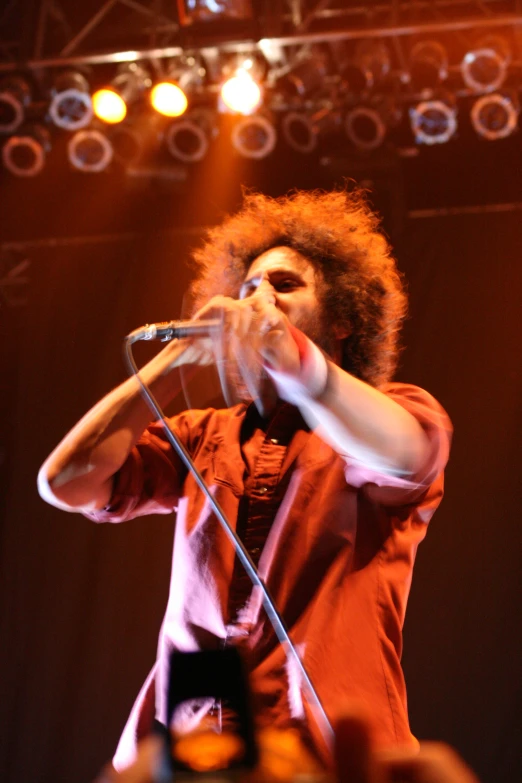 a man standing in front of a microphone on stage