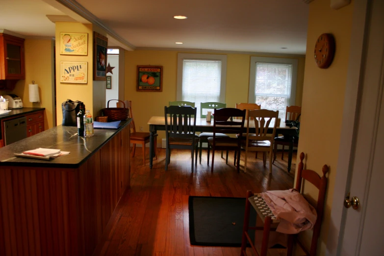 a large kitchen area with wood floors and a table in it