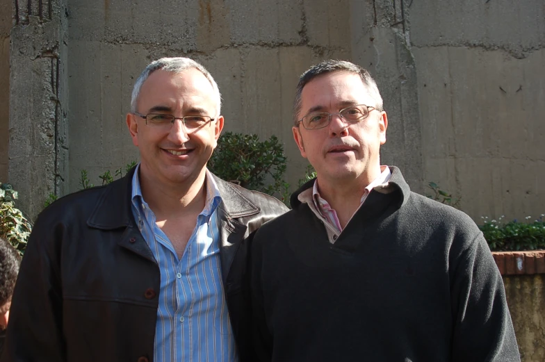 two men are standing in front of a building