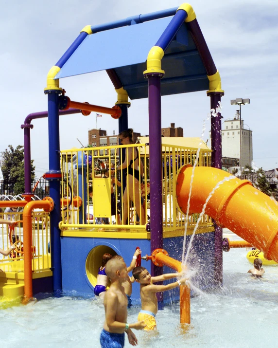 children playing in the pool at a water park