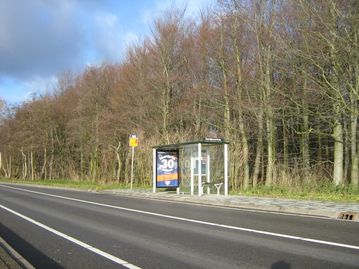 a bus stop next to an empty street