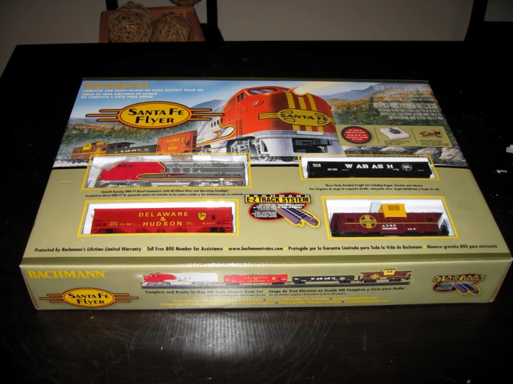 a very pretty red train set sitting on top of a box